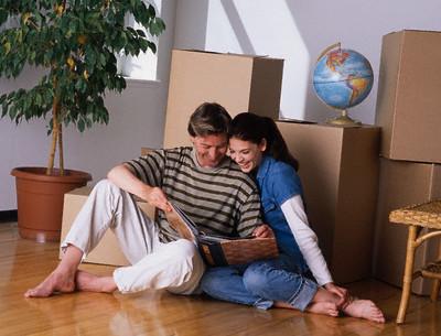 Couple Looking at Photo Album --- Image by © Don Hammond/Design Pics/Corbis